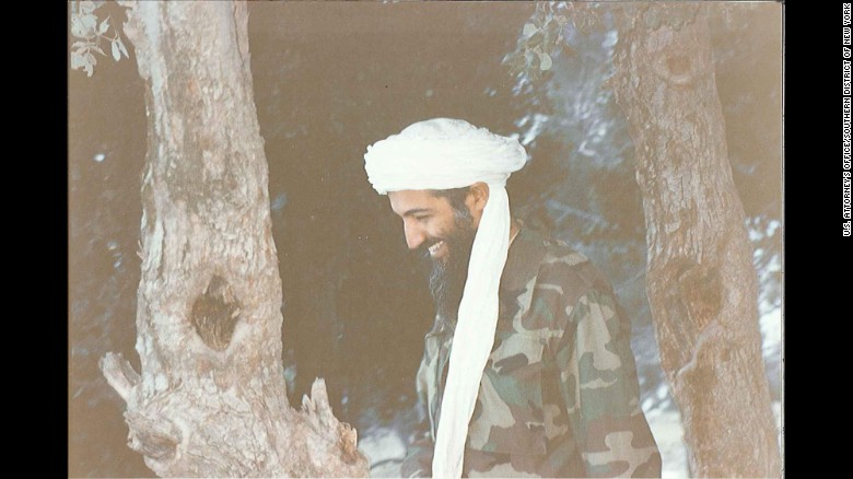 Bin Laden laughs during a walk near his modest compound in Tora Bora in 1996.jpg